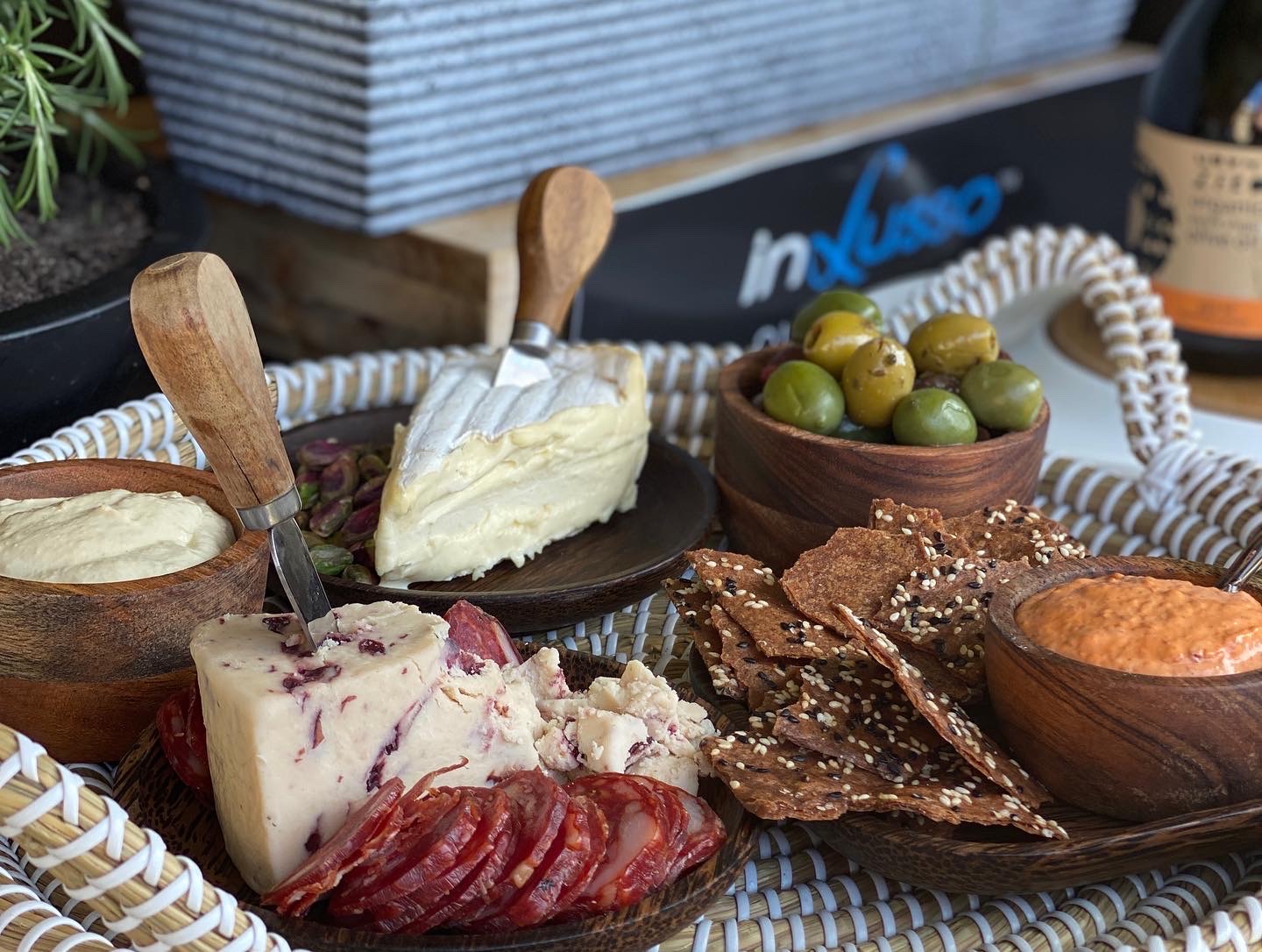 Cheese, salami, cracker and olives on a plate