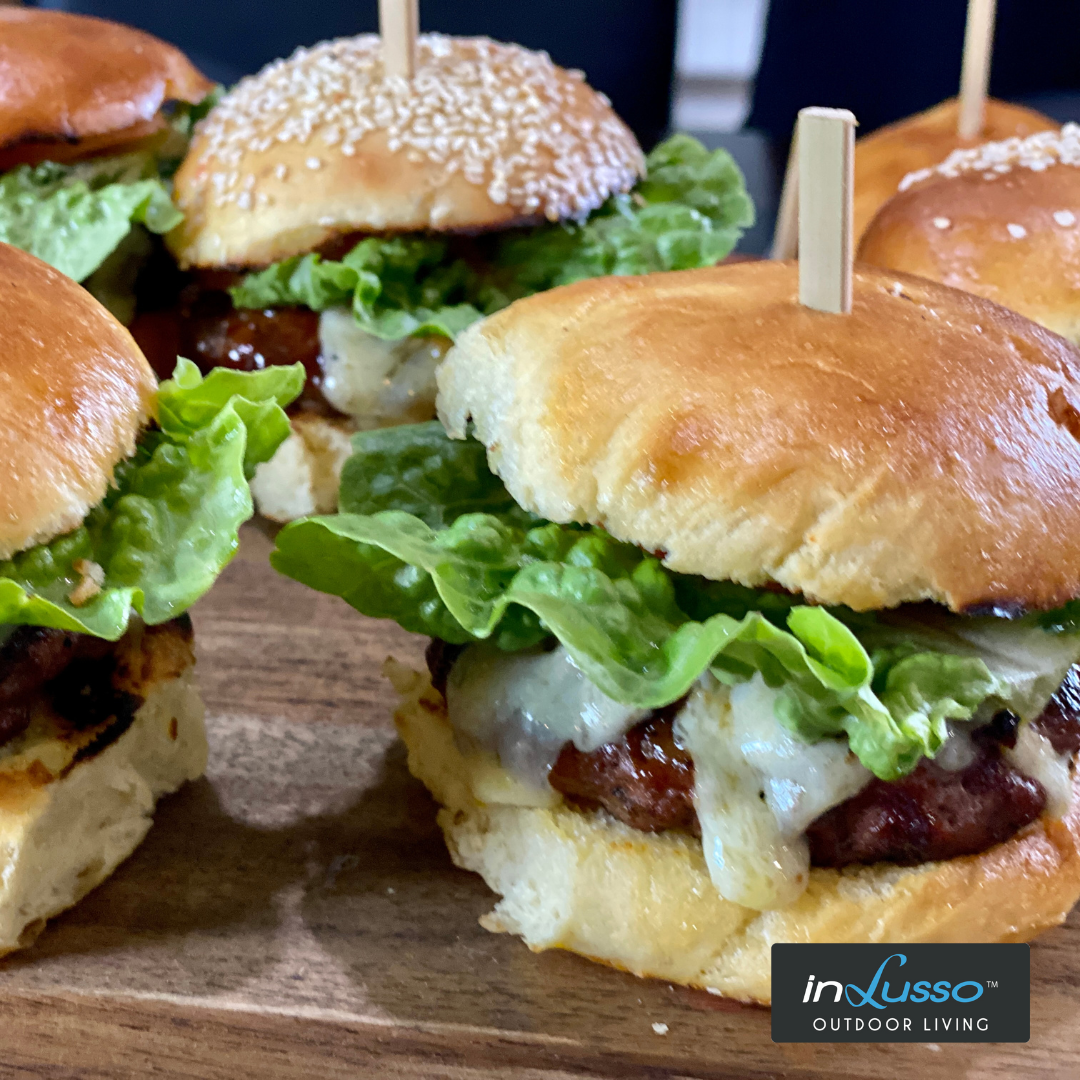 Home made beef burgers with home made buns, lettuce and melting cheese