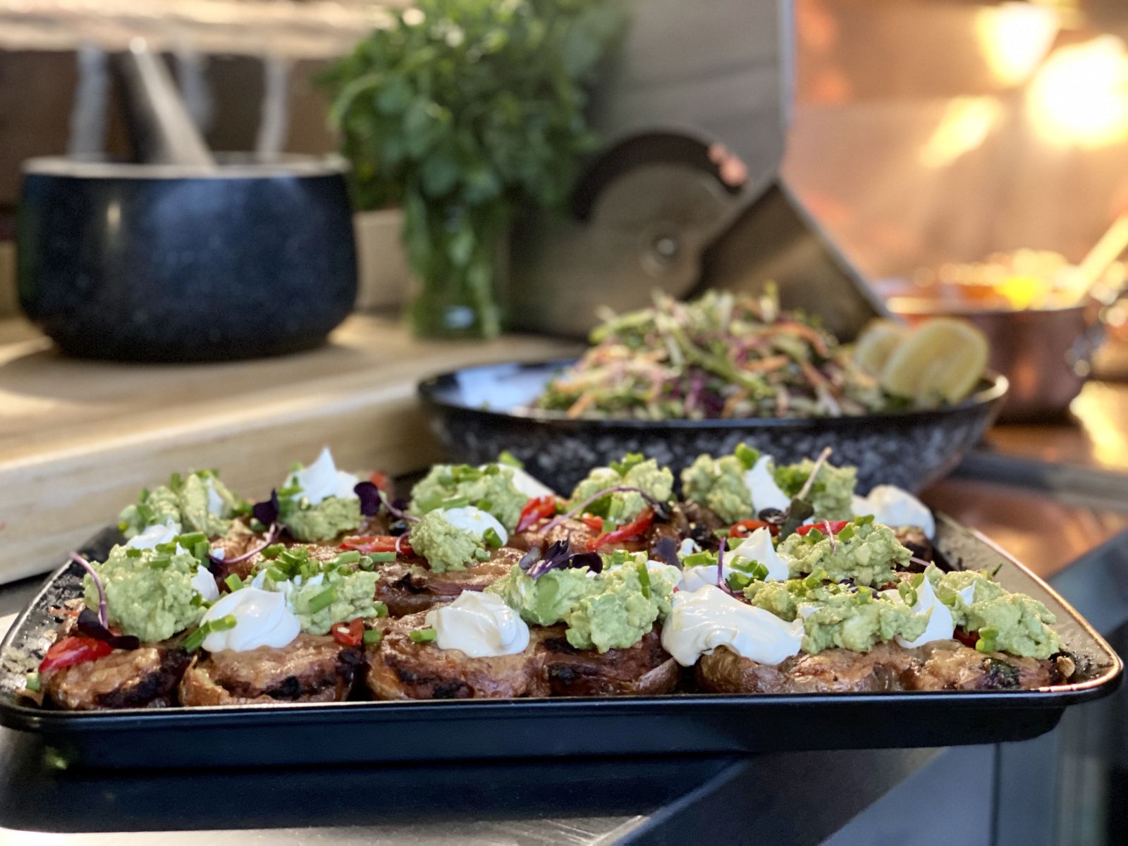 A plate of loaded potato skins and an outdoor kitchen bbq