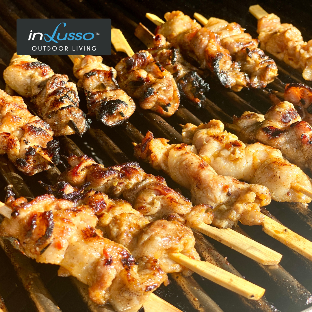 Mini chicken skewers cooking on a BBQ