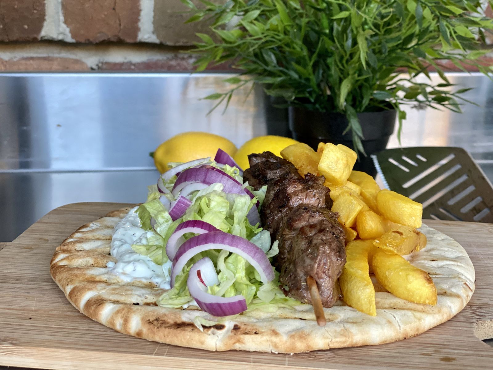 Beef skewers with salad and pita bread