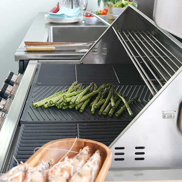 Side view of an inLusso stainless steel 6-burner BBQ with warming rack
