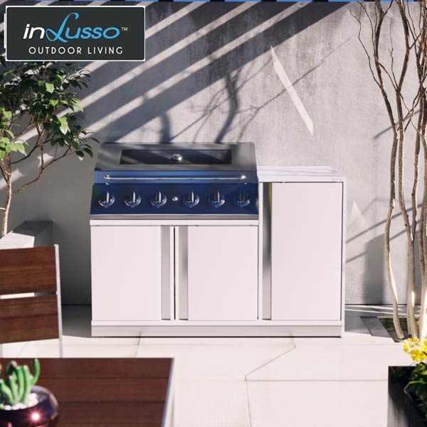 Compact outdoor BBQ kitchen with gas BBQ and white cabinets and draws in a Sydney courtyard