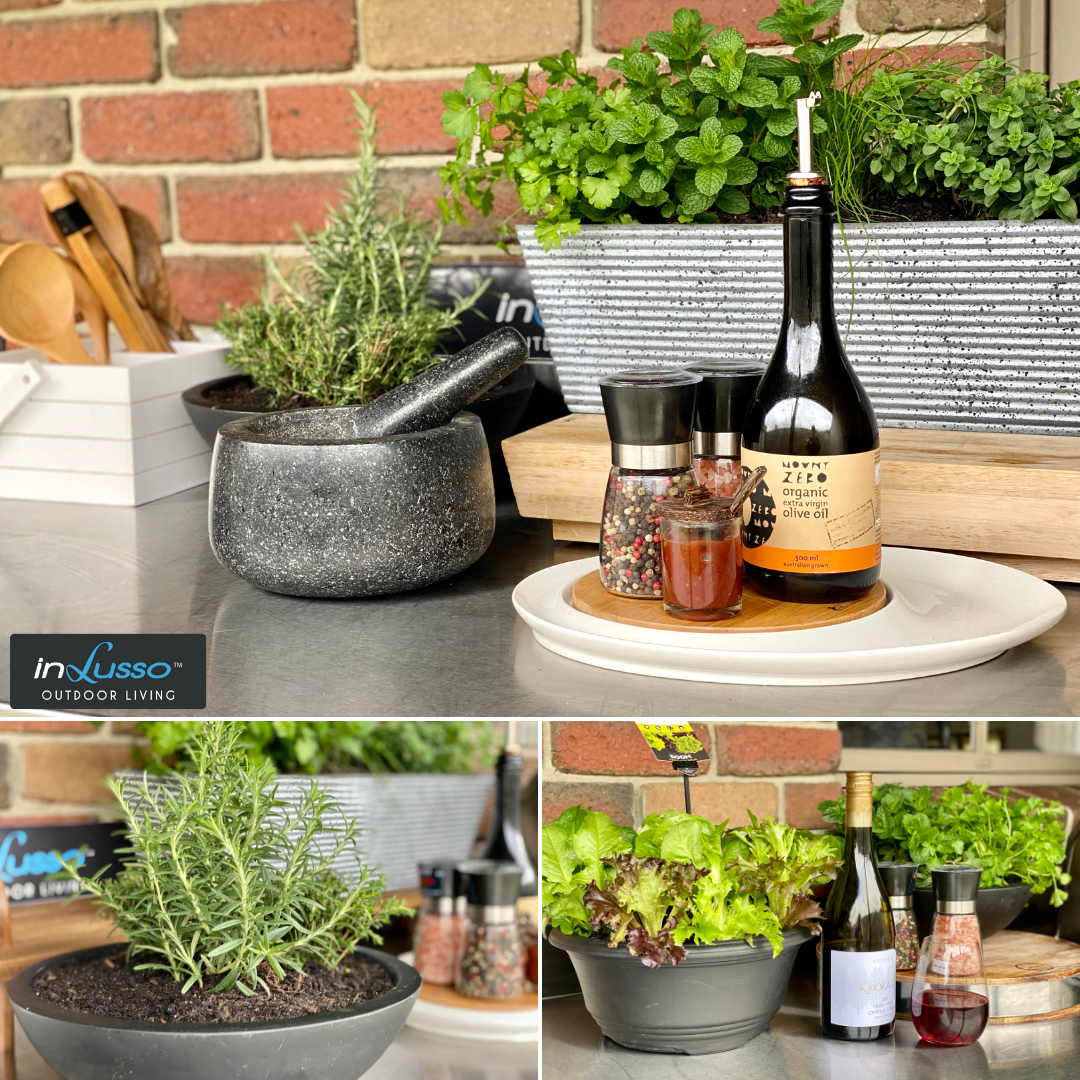 An outdoor BBQ kitchen with herbs and a herb box