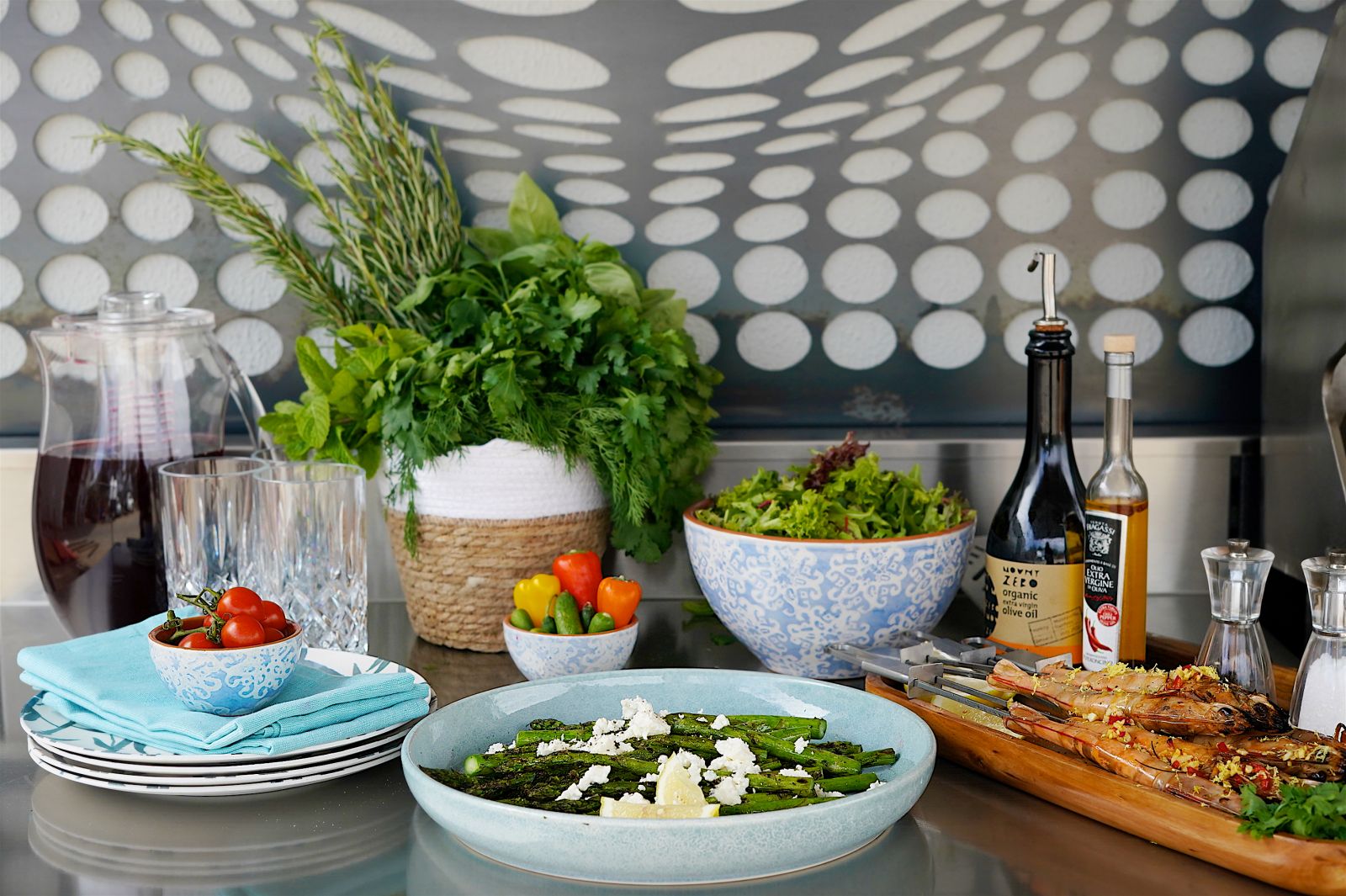 An outdoor kitchen styled with herbs, pots and decor in Sydney