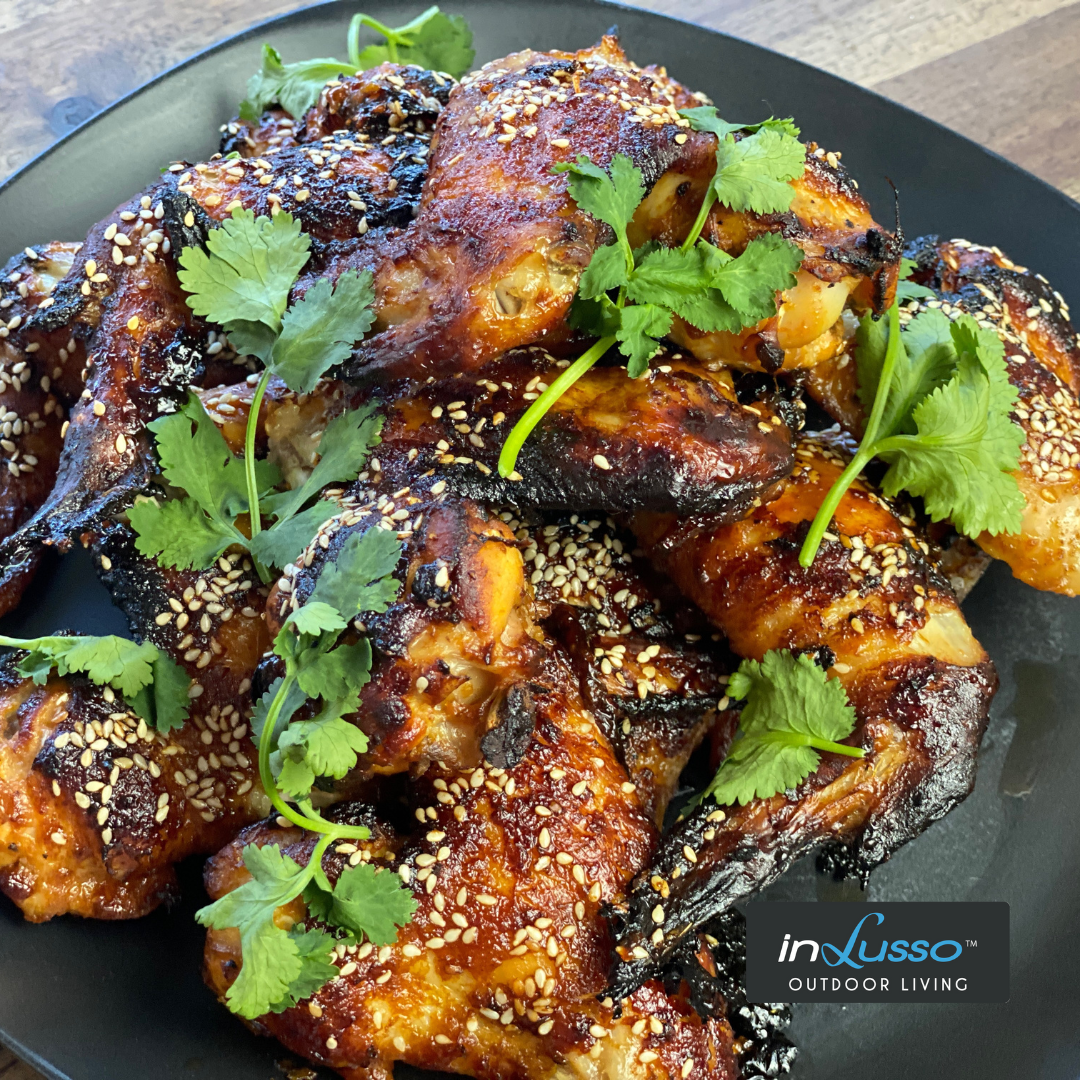 BBQ sesame and soy chicken wings with fresh coriander garnish